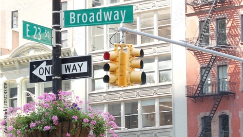 Broadway street road sign, Manhattan midtown architecture, New York City corner. Yellow traffic light. Flatiron district near Madison Square Park. Crossroad of 23 st., Bway and 5 Fifth avenue. One way