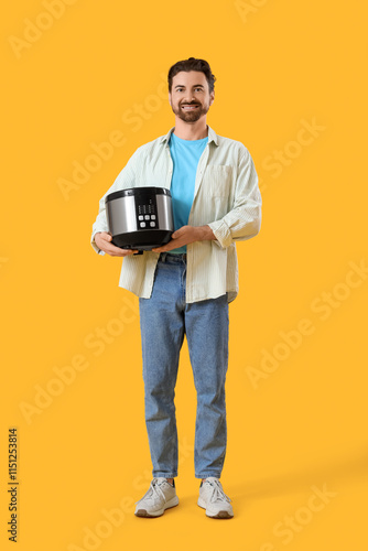 Young man with multi cooker...