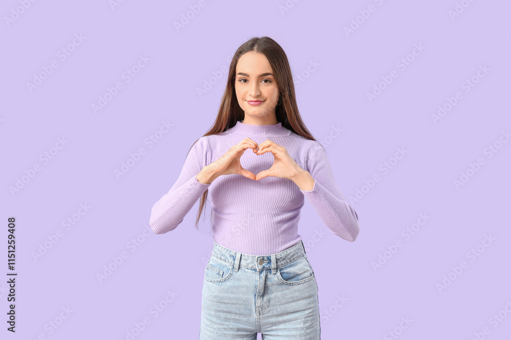 Beautiful young woman making heart with her hands on lilac background Beautiful young woman making heart with her hands on lilac background