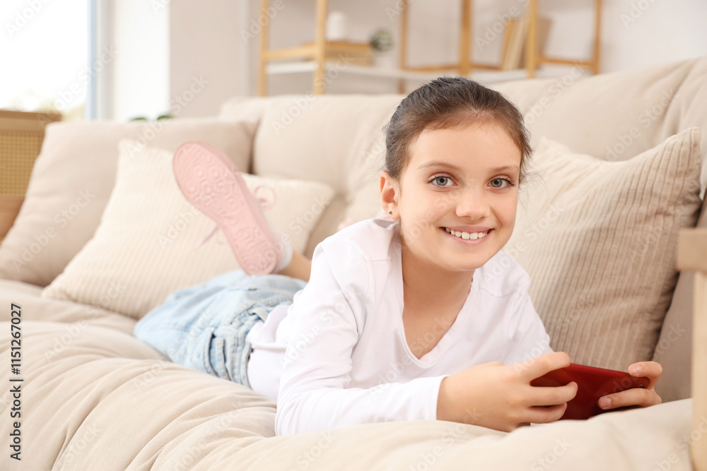 Teenage girl using mobile phone on sofa at home Teenage girl using mobile phone on sofa at home