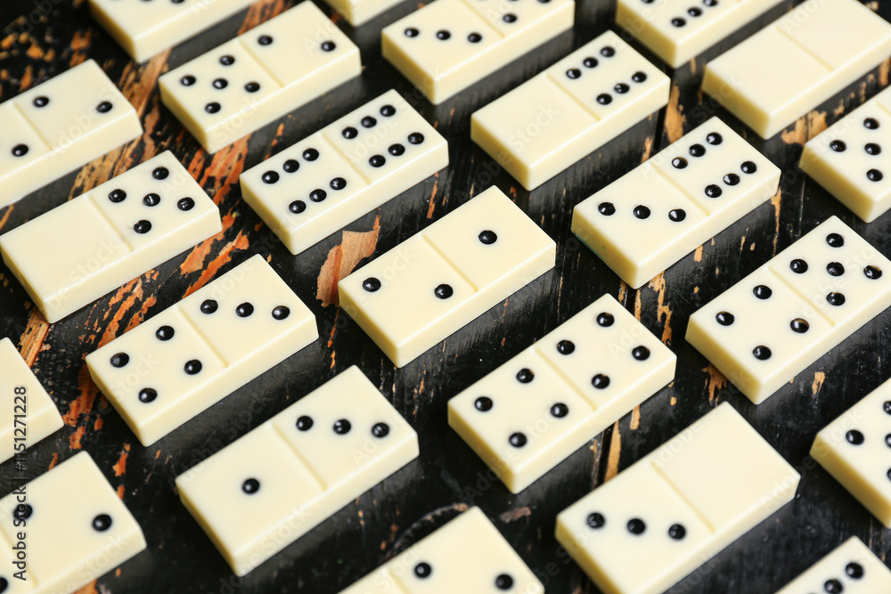 Texture of white dominos blocks on black wooden background Texture of white dominos blocks on black wooden background