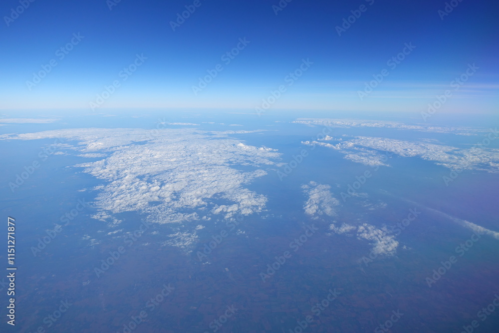 White clouds drift across the stratosphere against a blue sky. A few clouds dot the otherwise brilliant and pure sky. As if gazing up at a picturesque day, the scene is calm and tranquil. White clouds drift across the stratosphere against a blue sky. A few clouds dot the otherwise brilliant and pure sky. As if gazing up at a picturesque day, the scene is calm and tranquil.