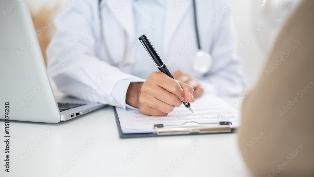 Fototapeta premium A close-up of a doctor filling out a medical form while examining a patient.