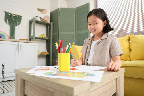 Cute little Asian girl draw...