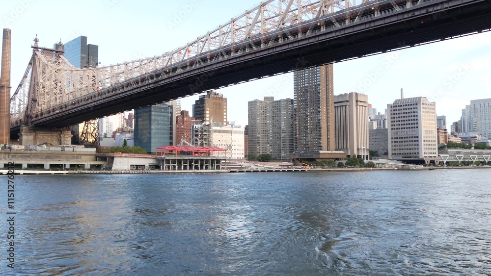 New York City waterfront skyline, Queensboro Bridge, Manhattan Midtown buildings, riverfront skyscrapers. Waterside cityscape view from Roosevelt Island. United States architecture and real estate. New York City waterfront skyline, Queensboro Bridge, Manhattan Midtown buildings, riverfront skyscrapers. Waterside cityscape view from Roosevelt Island. United States architecture and real estate.