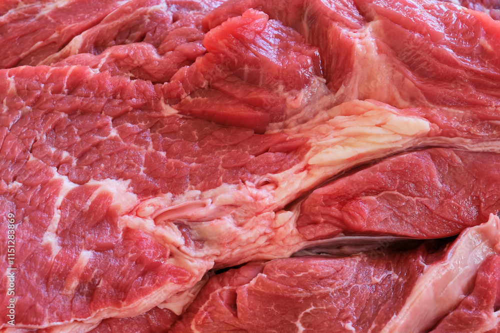 Closeup of raw shoulder top blade beef meat steaks to make stew. Red meat background. Top view image. Closeup of raw shoulder top blade beef meat steaks to make stew. Red meat background. Top view image.