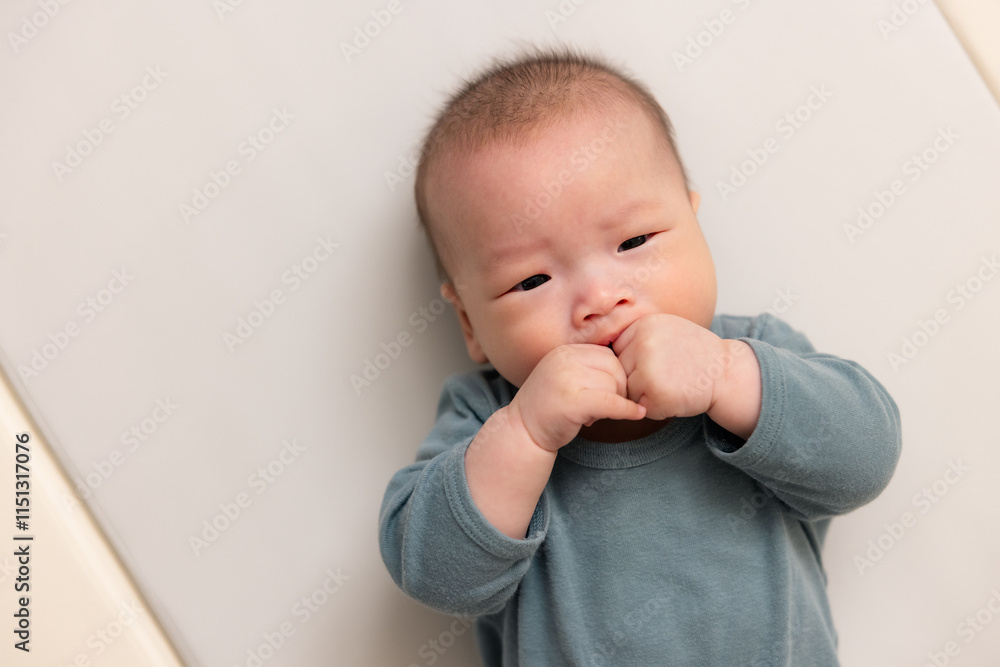 Close up of newborn baby sucking tiny hand Close up of newborn baby sucking tiny hand