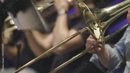 A trombone player playing a section solo during a classical youth symphony orchestra rehearsal. Nr.1