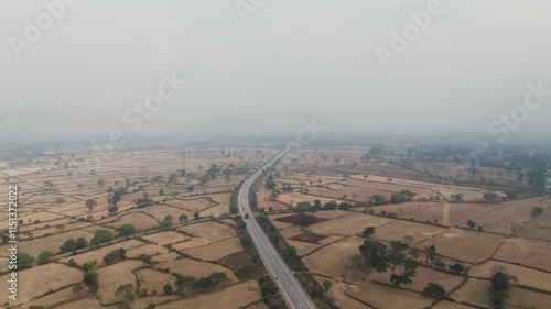 aerial view of farmland, rural landscape with fields, country road amidst farmlands, scenic aerial countryside, patchwork fields aerial view, rural area with greenery and road, raighar highway road. photo