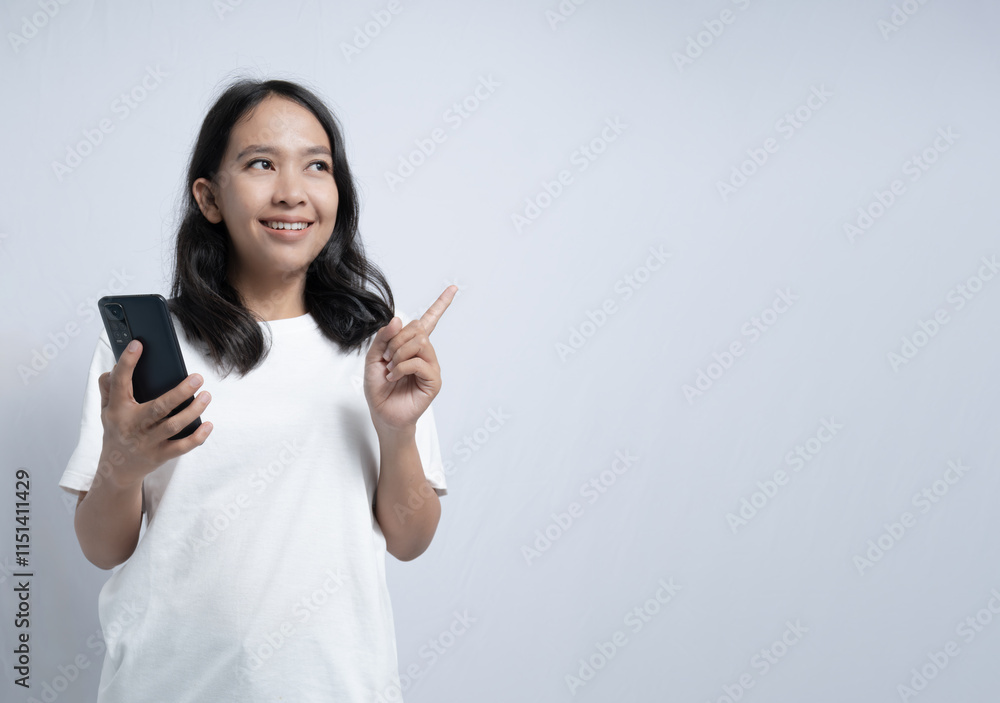 Smiling Woman Holding Phone and Pointing with White Background Smiling Woman Holding Phone and Pointing with White Background