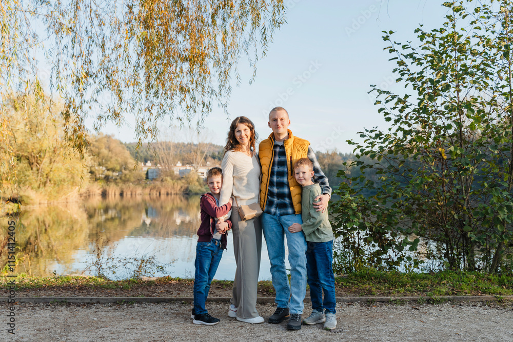 Happy family standing near pond at park Happy family standing near pond at park