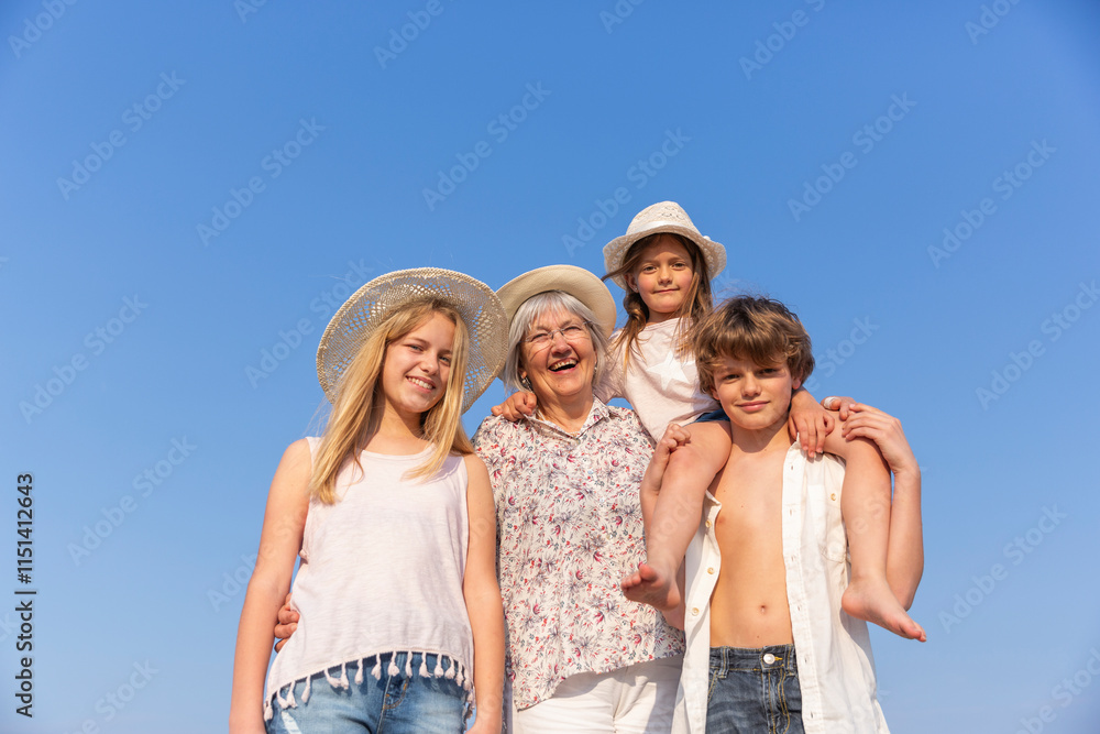 Grandmother with grandchildren under blue sky Grandmother with grandchildren under blue sky