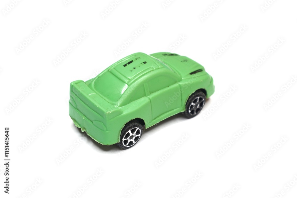A small green toy car is isolated on a white background. A small green toy car is isolated on a white background.