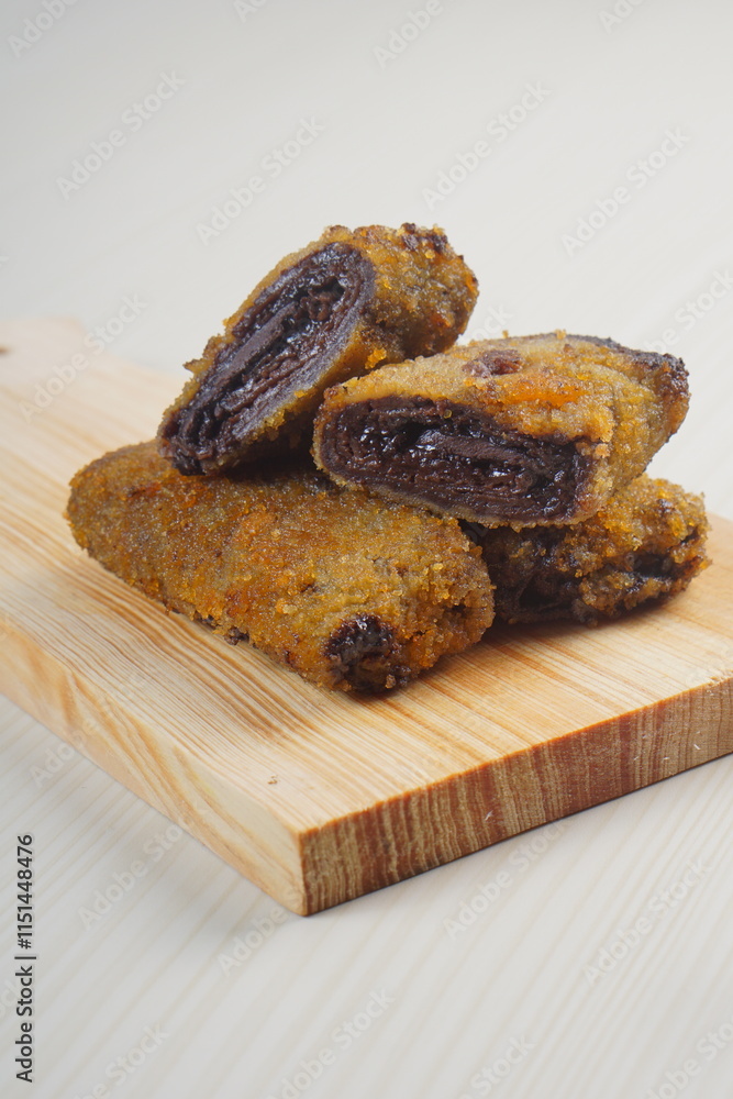 vegetables risoles enclosed in crepe-like wrappers and rolled into bread crumbs and fried. served on wood plate. perfect for recipe, article, catalogue, promotion, or any cooking contents. vegetables risoles enclosed in crepe-like wrappers and rolled into bread crumbs and fried. served on wood plate. perfect for recipe, article, catalogue, promotion, or any cooking contents.