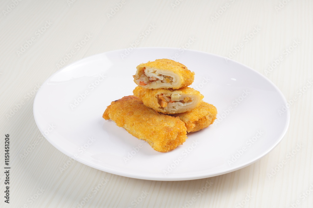 vegetables risoles enclosed in crepe-like wrappers and rolled into bread crumbs and fried. served on wood plate. perfect for recipe, article, catalogue, promotion, or any cooking contents. vegetables risoles enclosed in crepe-like wrappers and rolled into bread crumbs and fried. served on wood plate. perfect for recipe, article, catalogue, promotion, or any cooking contents.