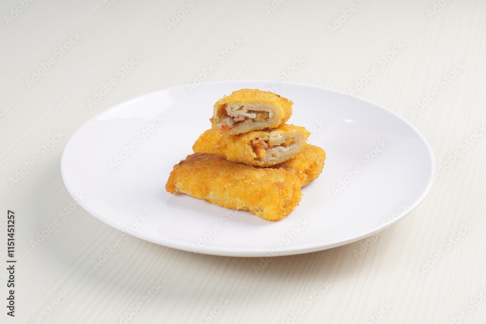 vegetables risoles enclosed in crepe-like wrappers and rolled into bread crumbs and fried. served on wood plate. perfect for recipe, article, catalogue, promotion, or any cooking contents. vegetables risoles enclosed in crepe-like wrappers and rolled into bread crumbs and fried. served on wood plate. perfect for recipe, article, catalogue, promotion, or any cooking contents.