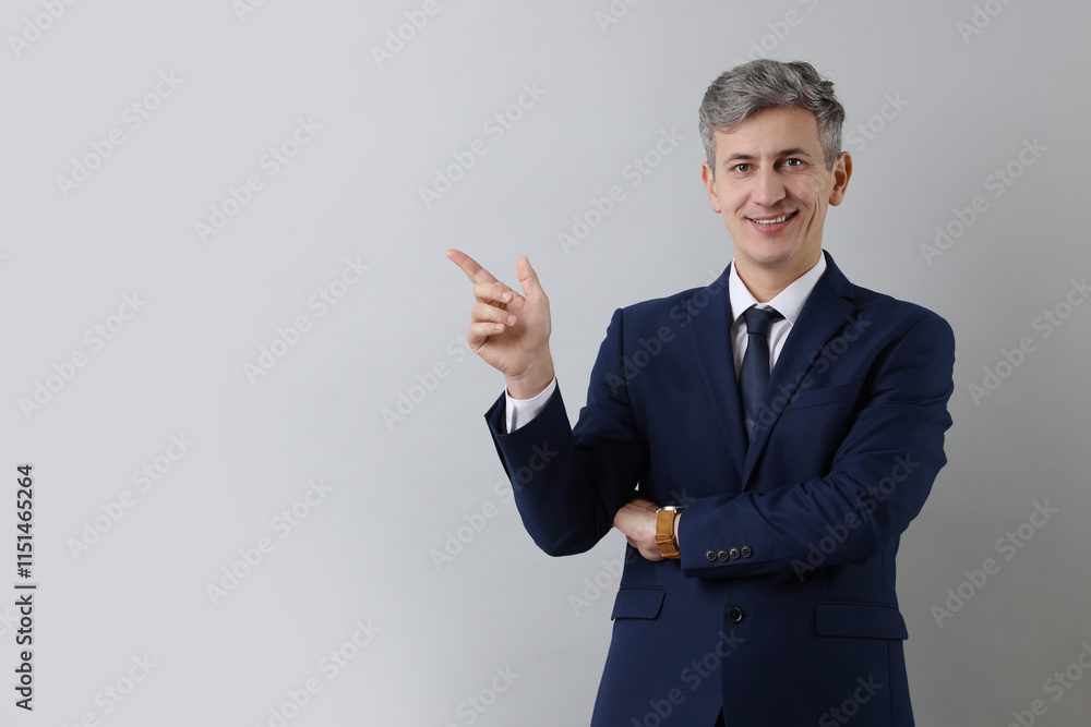 Portrait of businessman on light grey background, space for text Portrait of businessman on light grey background, space for text