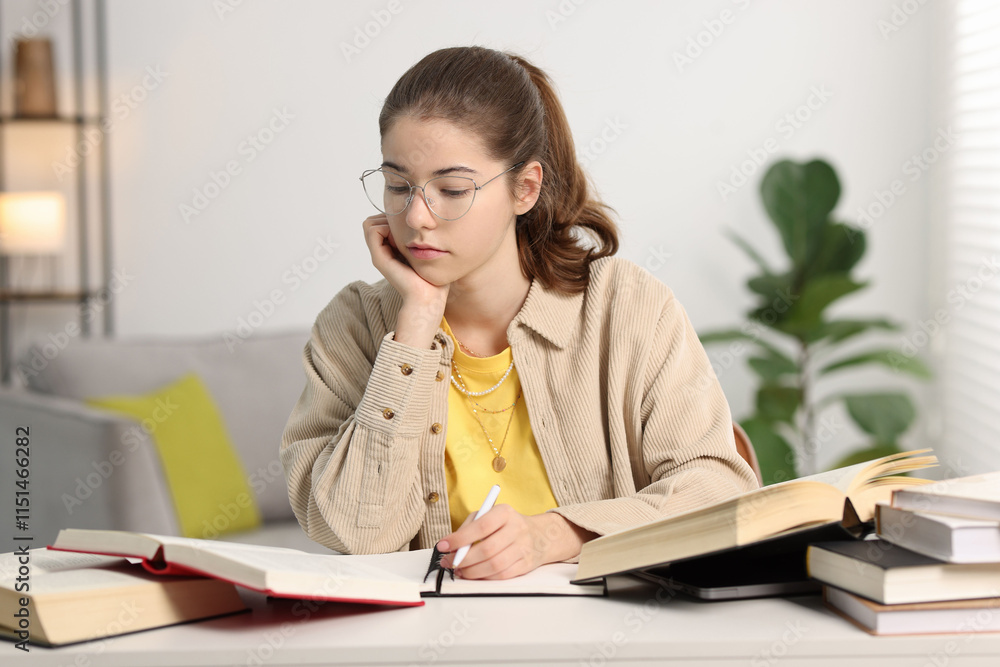 Student preparing for exam at table indoors Student preparing for exam at table indoors