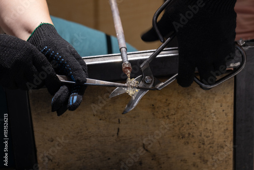Molten glass sculpting, works of a  glass blowing workshop in progress