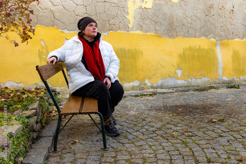A plus-size woman strolling through the streets of a small European town.