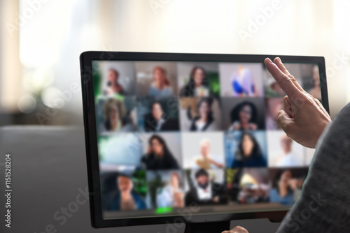 Man talking with diverse colleagues on virtual video conference using computer at home. Man working remotely in a home office, actively communicating during a virtual conference call