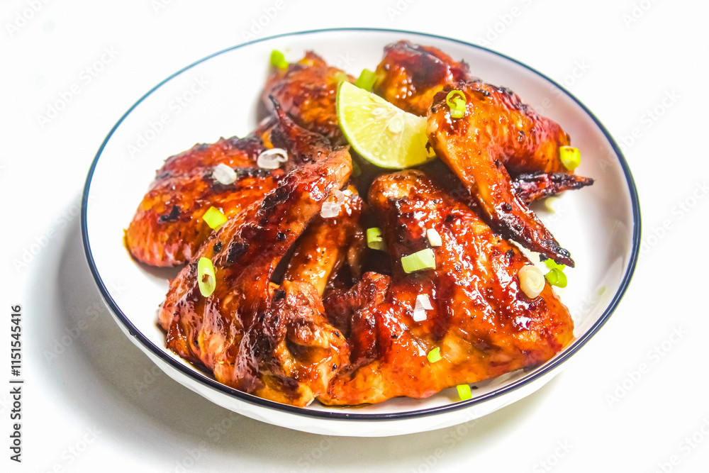 a piece of grilled chicken wings on a white background a piece of grilled chicken wings on a white background