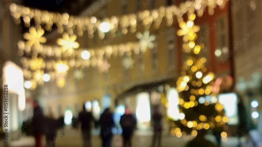 People walking on a street with beautiful Christmas decorations and lights, at night. Blurred 4k