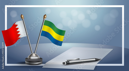 Bahrain and Gabon National flags on small table with bokeh background, cooperative relationship