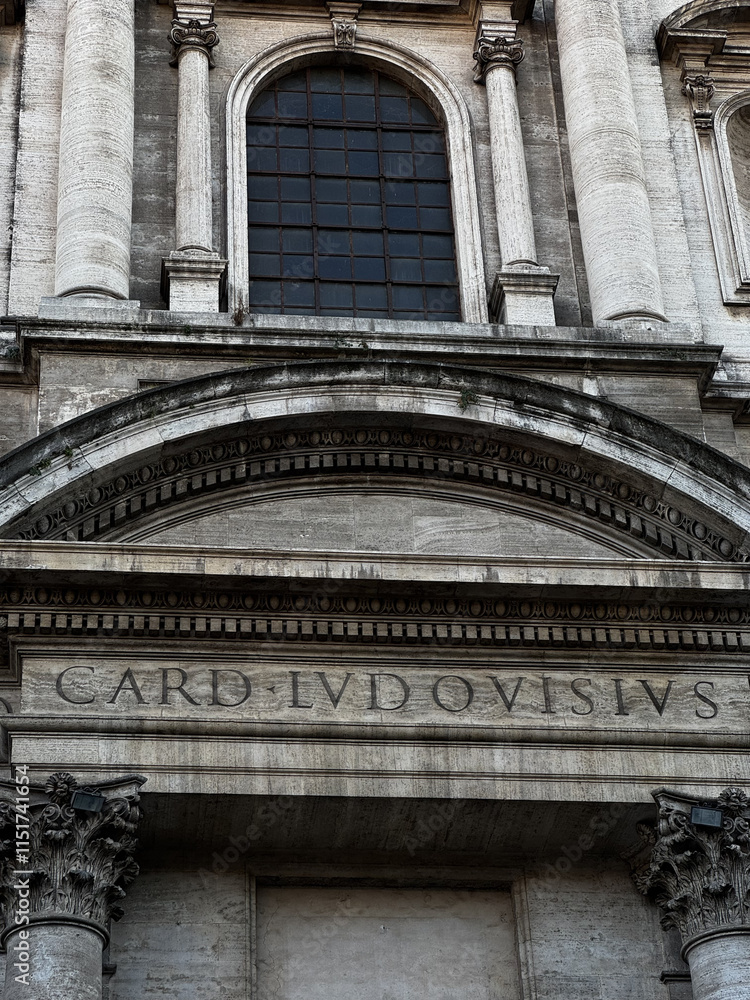 Intricate architectural details of a historic building with carved stone inscriptions and large arched windows in an urban environment Intricate architectural details of a historic building with carved stone inscriptions and large arched windows in an urban environment