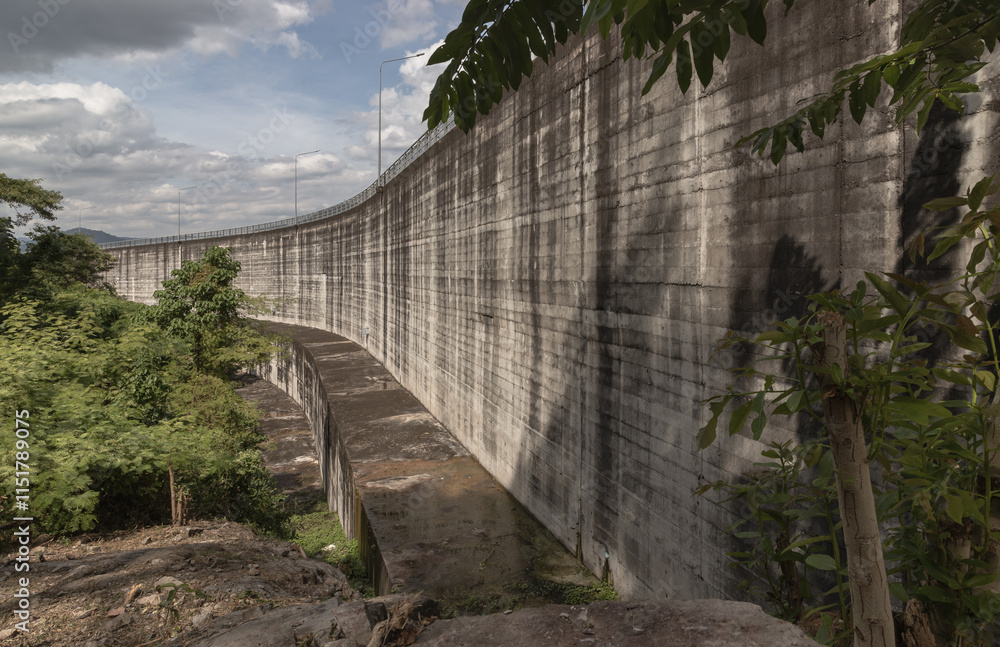 Part of Khun Dan Prakan Chon Dam was formerly named Khlong Tha Dan Dam. is the longest concrete - crushed construction in the world (RCC) with sky and clouds in the background.use it as your Wallpaper