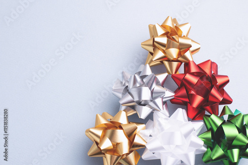 Close-up of elegant Christmas ornaments on a blue-grey background. Shiny metallic details with copy space for holiday greetings or designs.