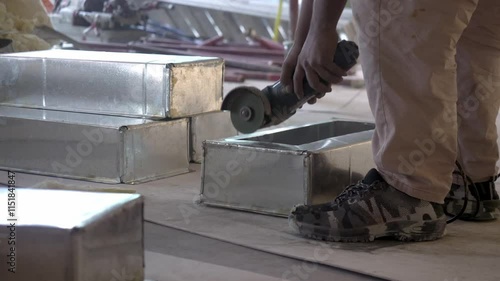 Grinding a cutout ventilation with sparks during office renovation