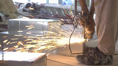 Grind open a metal ventilation with sparks during office renovation