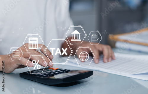 Finance or income concept. calculating taxes online. Personal income statement, man using calculator to fill out personal or business income tax payment form for government agency on virtual screen photo