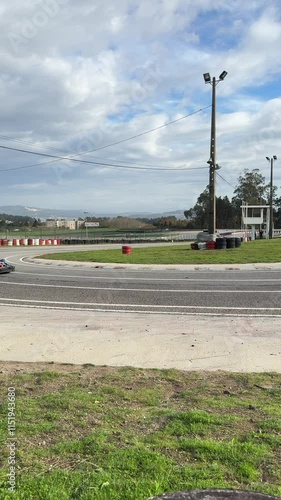 Baltar, Portugal, November 16, 2024: SLOW MOTION SHOT - Kart drivers moving on a go-kart track passing by the camera. Amateur racers are driving their karts on a race track. photo