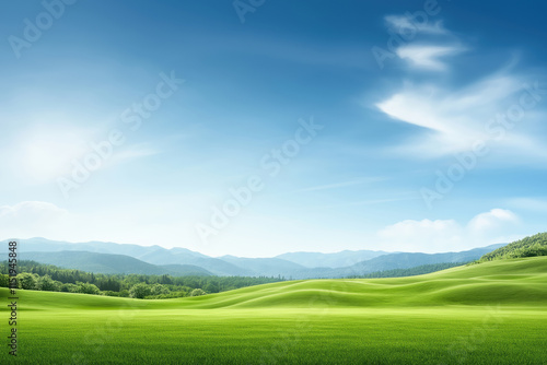 Open green landscape with rolling hills and a clear blue sky in daylight