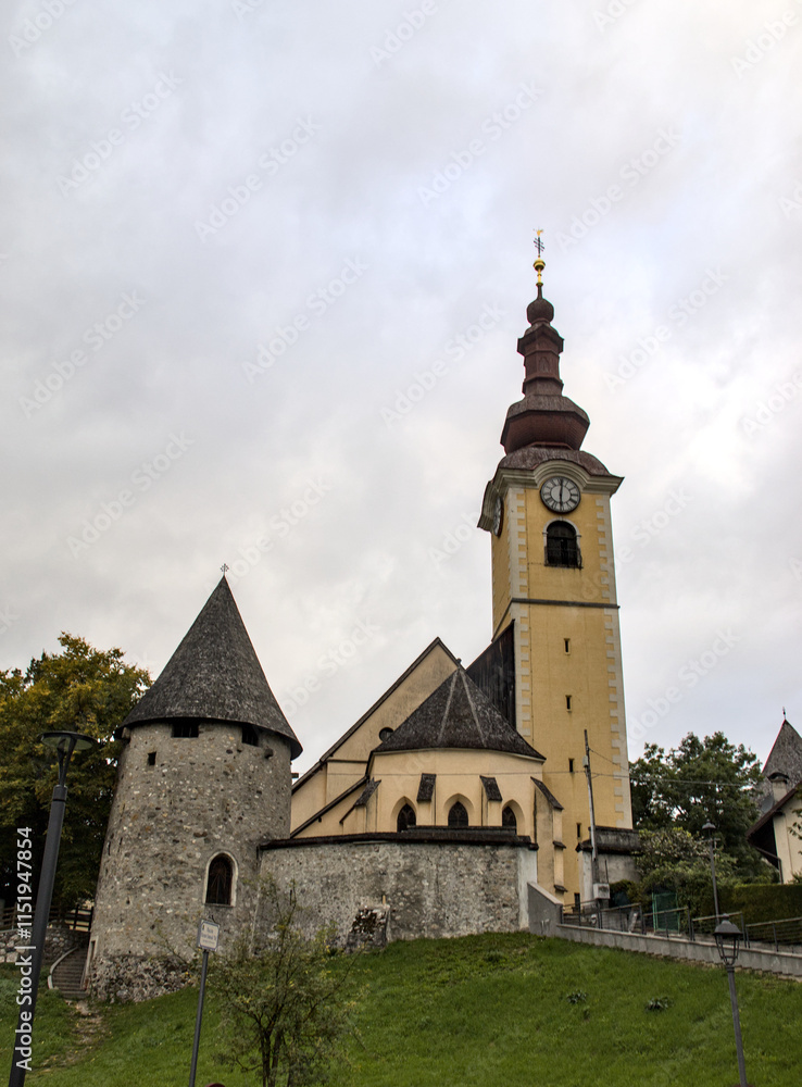 view of famous church tower in downtown tarvisio italy (julian alps) beautiful town view of famous church tower in downtown tarvisio italy (julian alps) beautiful town
