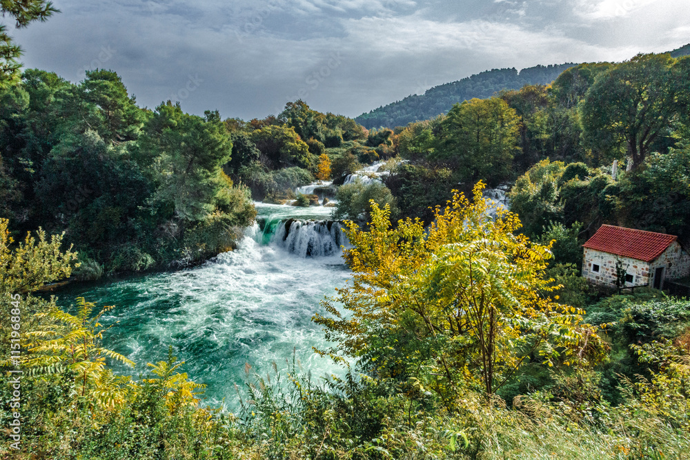 Krka National Park, Šibenik-Knin – HR - Oct 17, 2024 Skradinski buk waterfall, with cascading tiers, lush greenery, and crystal-clear turquoise waters.