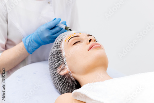 A cosmetologist performs a chemical peel on a young woman's face in a professional beauty salon. Concept of effective skincare, rejuvenation, and skin renewal. photo