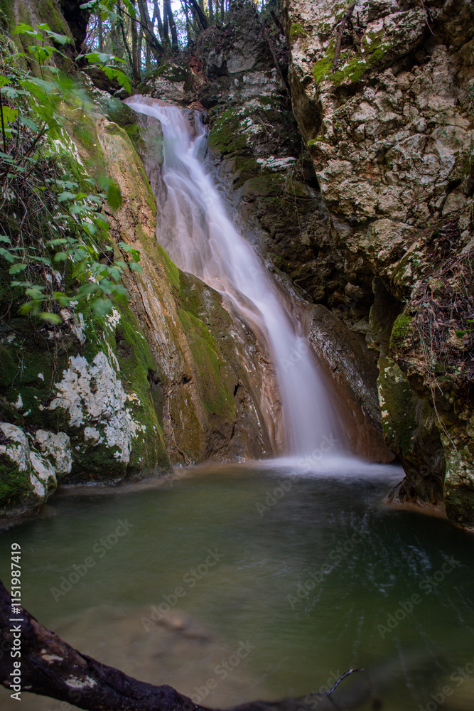Serene waterfall cascading into a tranquil pool, surrounded by lush greenery and mossy rocks. Serene waterfall cascading into a tranquil pool, surrounded by lush greenery and mossy rocks.