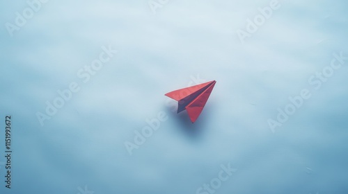 Red Paper Airplane Soaring Through A Blue Sky photo