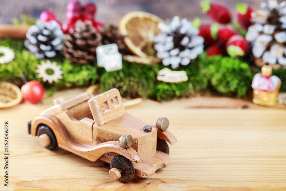 Wooden toy car among classic Christmas decorations.