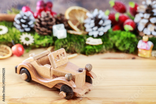 Obraz na płótnie Wooden toy car among classic Christmas decorations. w salonie