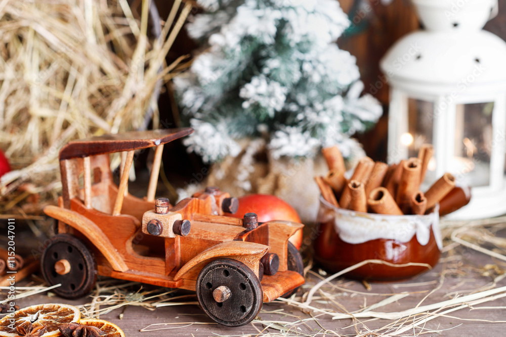 Wooden toy car among classic Christmas decorations.