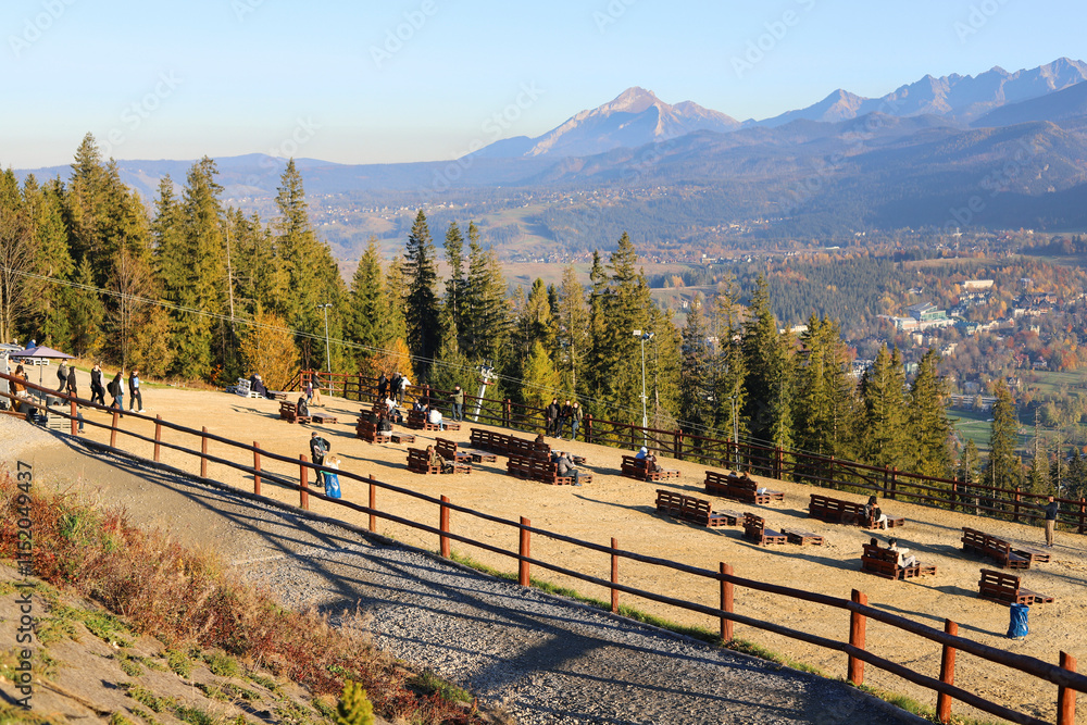 ZAKOPANE, POLAND - OCTOBER 24, 2024: Terraces with sand and deckchairs for tourists on the top of Gubalowka, Zakopane, Poland.