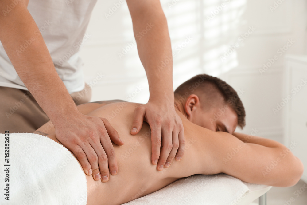 Massage therapist working with patient in clinic, closeup Massage therapist working with patient in clinic, closeup