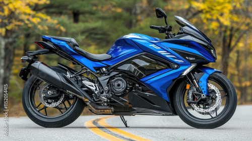 High resolution photograph of blue motorcycle on road surrounded by autumn trees photo