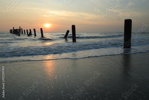 Inclined Column Beach, scenery view of the concrete columns from the old port with beautiful sky on Sao Iang Beach at Phetchaburi province,Thailand photo