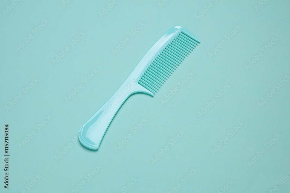 Set of plastic combs on mint green background. Top view Set of plastic combs on mint green background. Top view