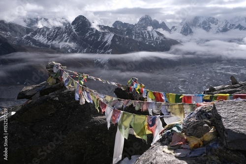 Peak Gokyo Ri with buddhist flags and amazing panorama of Himalayas. Gokyo is famous region in Himalayas in Nepal.  photo